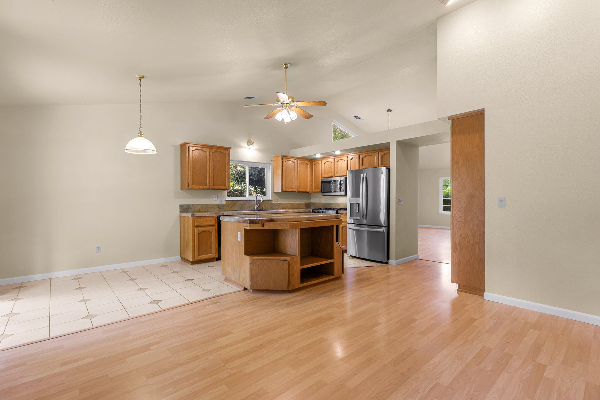 550 Vansicklen Way Redding, CA 96003 - Photo 15 of 52 a kitchen with stainless steel appliances kitchen island granite countertop a stove a refrigerator and a sink