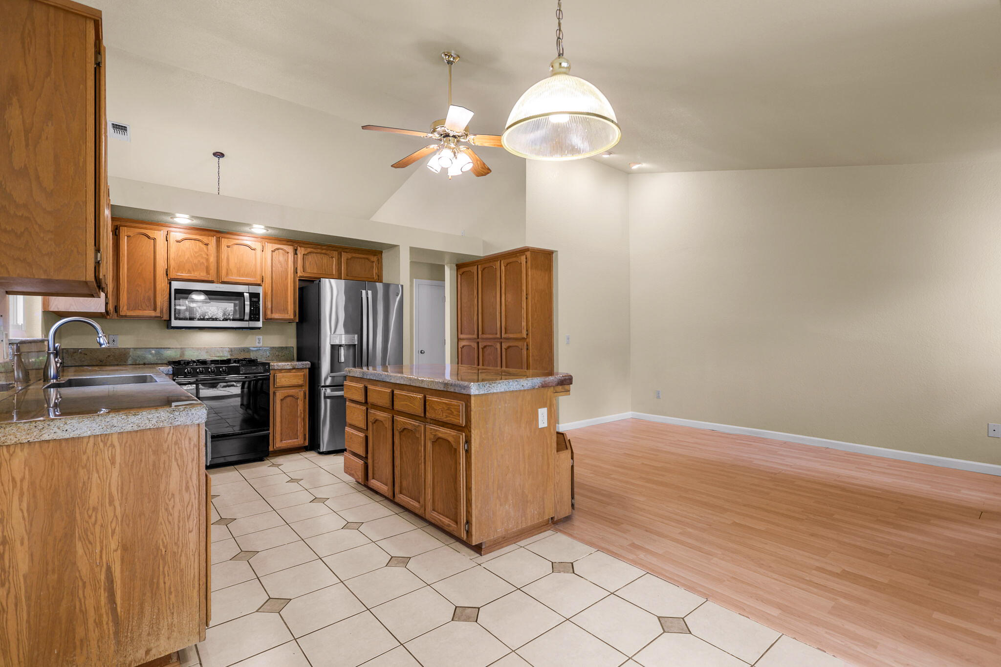 550 Vansicklen Way Redding, CA 96003 - Photo 17 of 52 a kitchen with stainless steel appliances granite countertop a refrigerator a stove a sink and dishwasher
