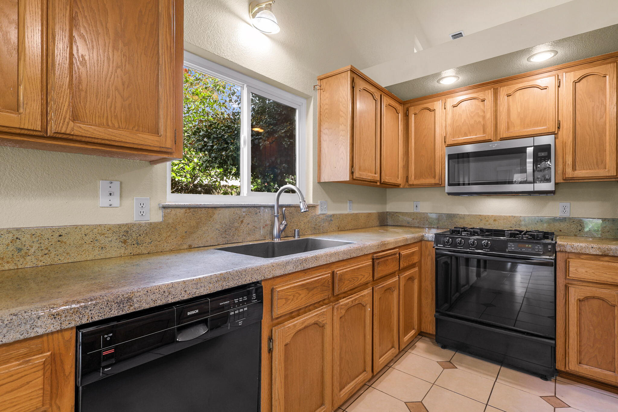 550 Vansicklen Way Redding, CA 96003 - Photo 18 of 52 a kitchen with stainless steel appliances granite countertop a sink stove and microwave
