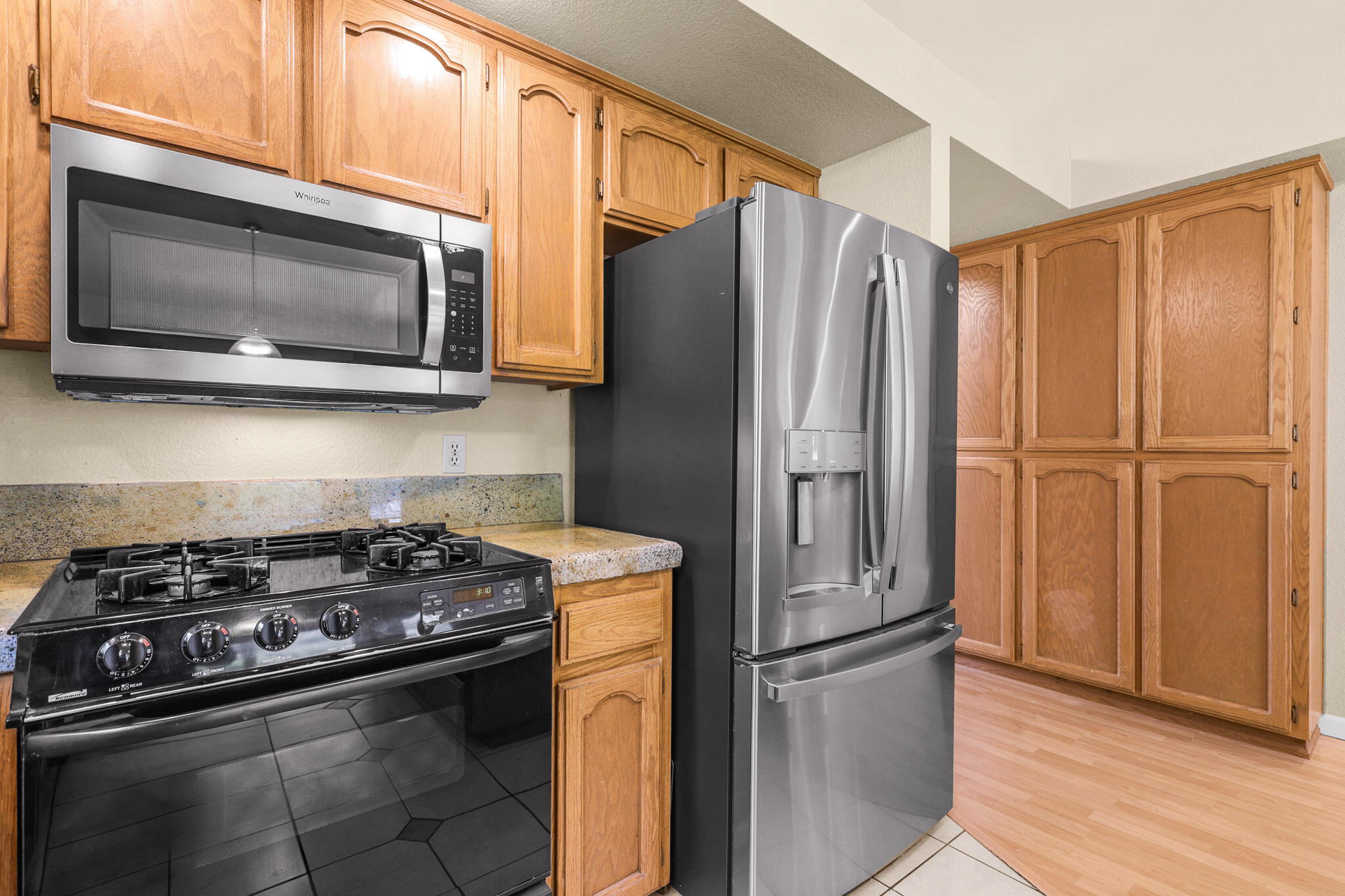 550 Vansicklen Way Redding, CA 96003 - Photo 19 of 52 a kitchen with stainless steel appliances granite countertop a refrigerator stove and microwave