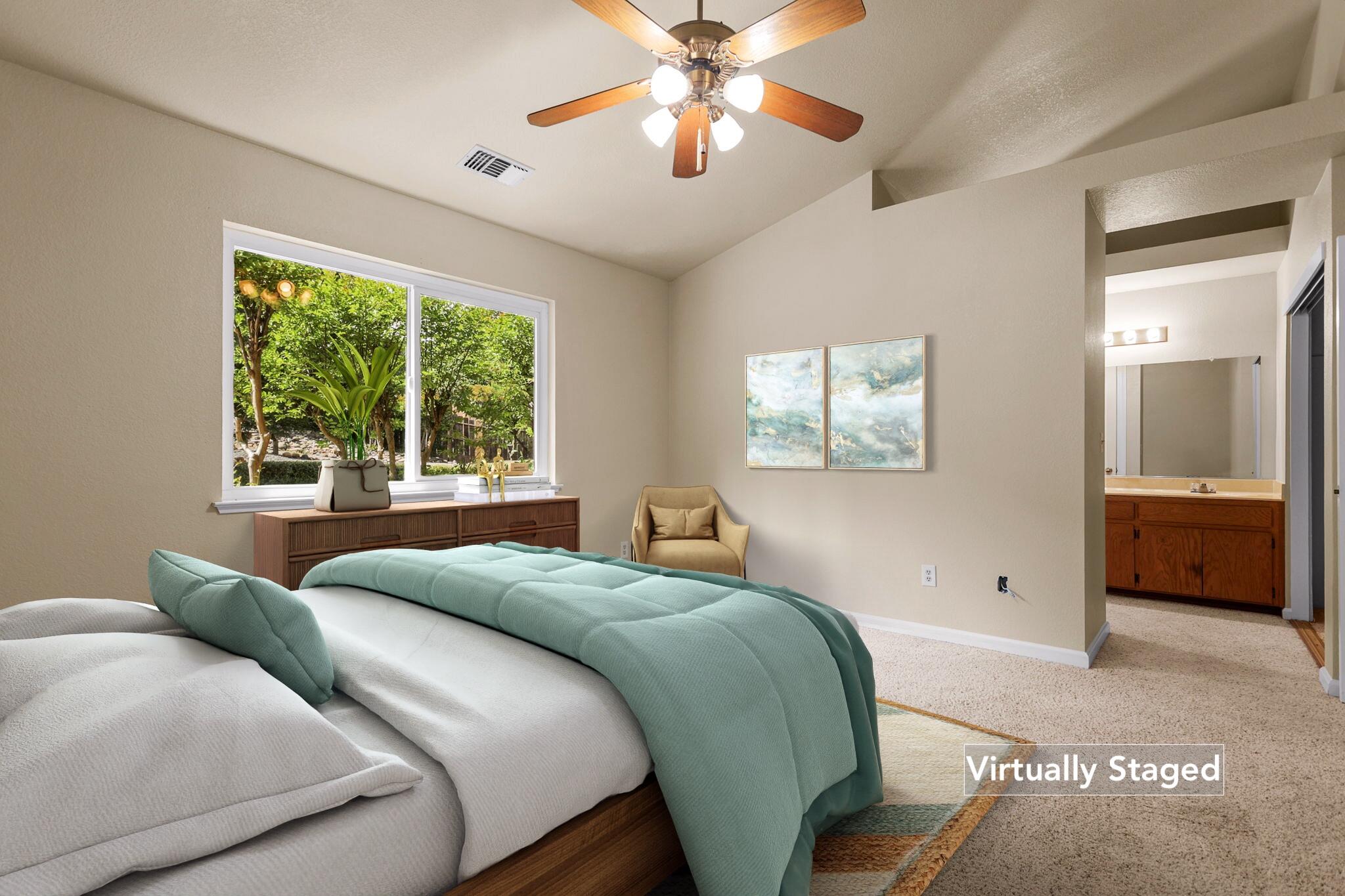550 Vansicklen Way Redding, CA 96003 - Photo 25 of 52 a bedroom with a large bed and a chandelier