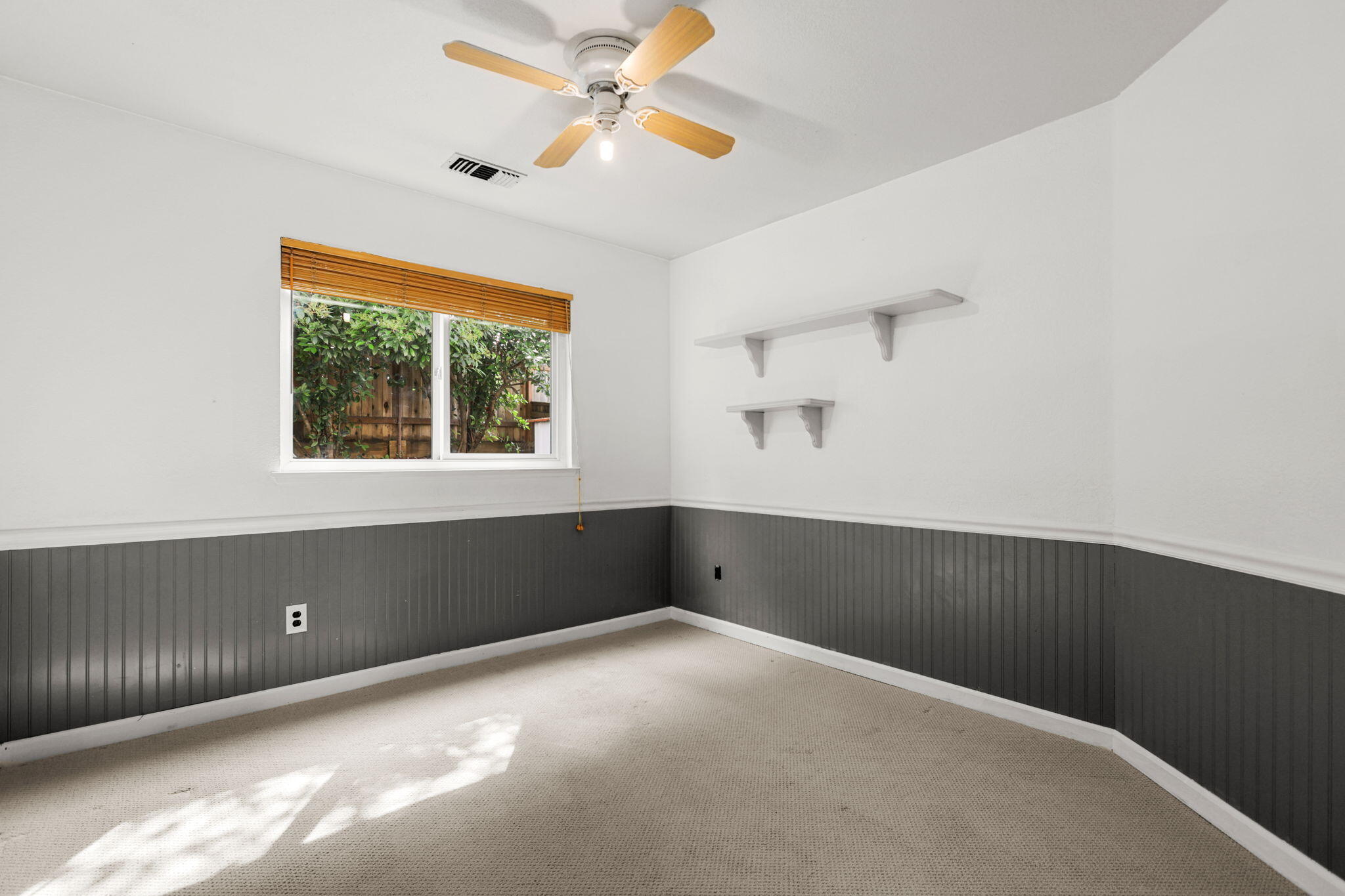 550 Vansicklen Way Redding, CA 96003 - Photo 36 of 52 an empty room with a window and a ceiling fan