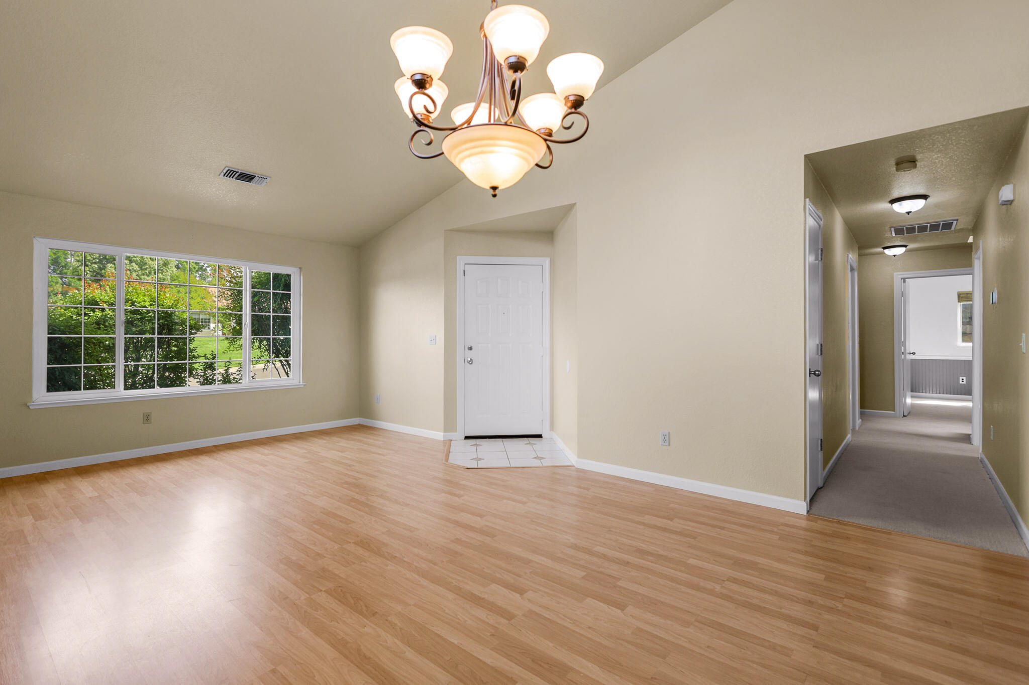 550 Vansicklen Way Redding, CA 96003 - Photo 8 of 52 a view of an empty room with wooden floor and a window