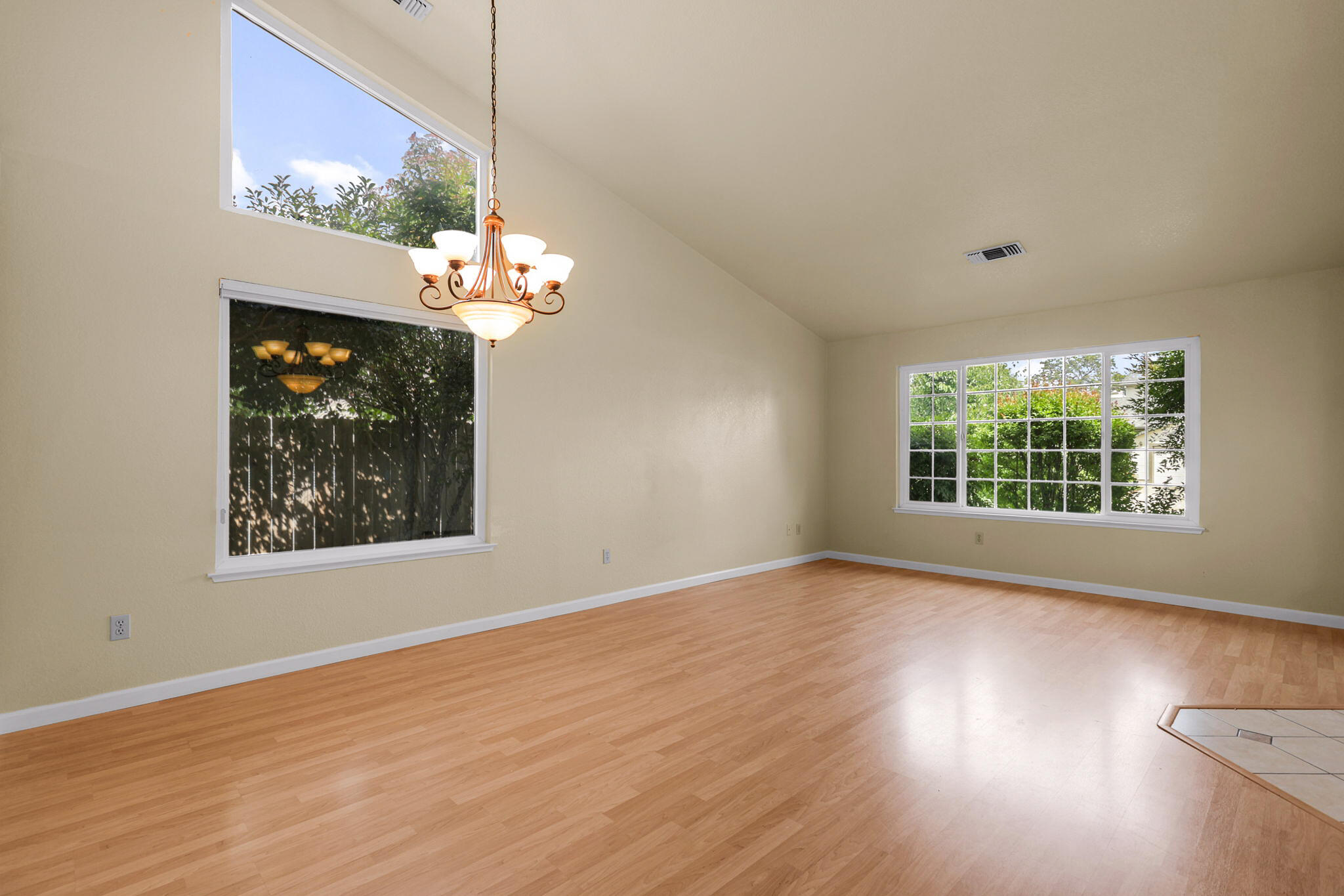 550 Vansicklen Way Redding, CA 96003 - Photo 10 of 52 a view of an empty room with wooden floor and a window
