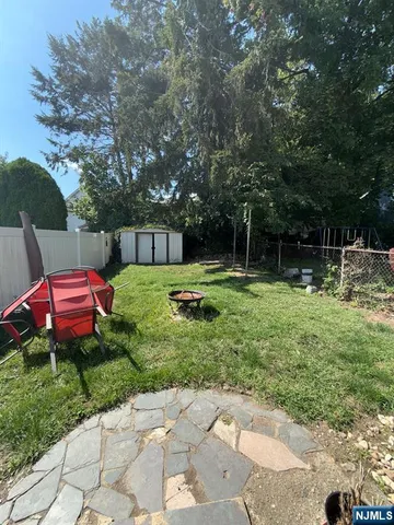a backyard of a house with barbeque oven table and chairs