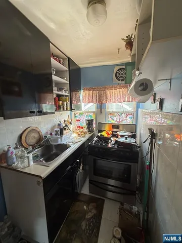 a kitchen with a sink stove and cabinets