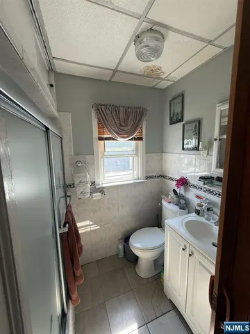 a bathroom with a sink toilet and a mirror