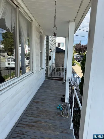a view of a hallway with wooden floor and stairs