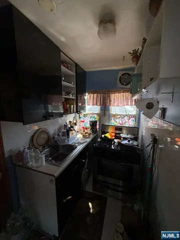 a kitchen with a sink a stove and a refrigerator