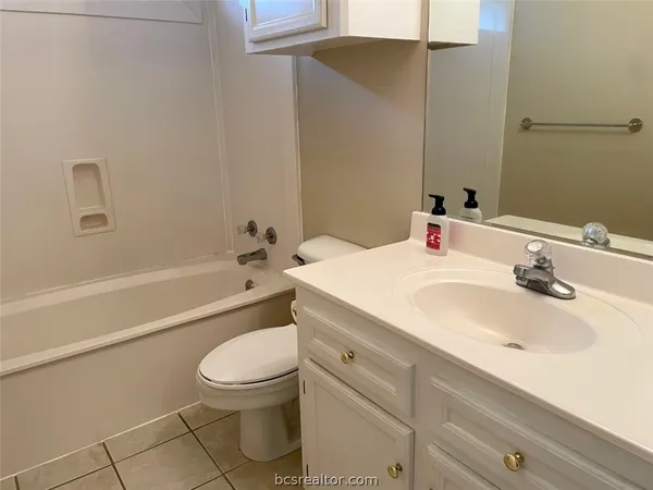 an empty room with wooden floor and a window