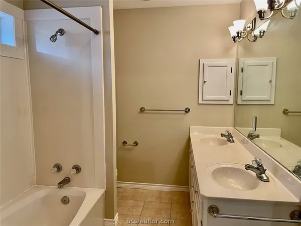 an empty room with wooden floor fan and window