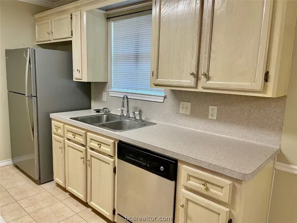 a kitchen with a sink a stove and cabinets