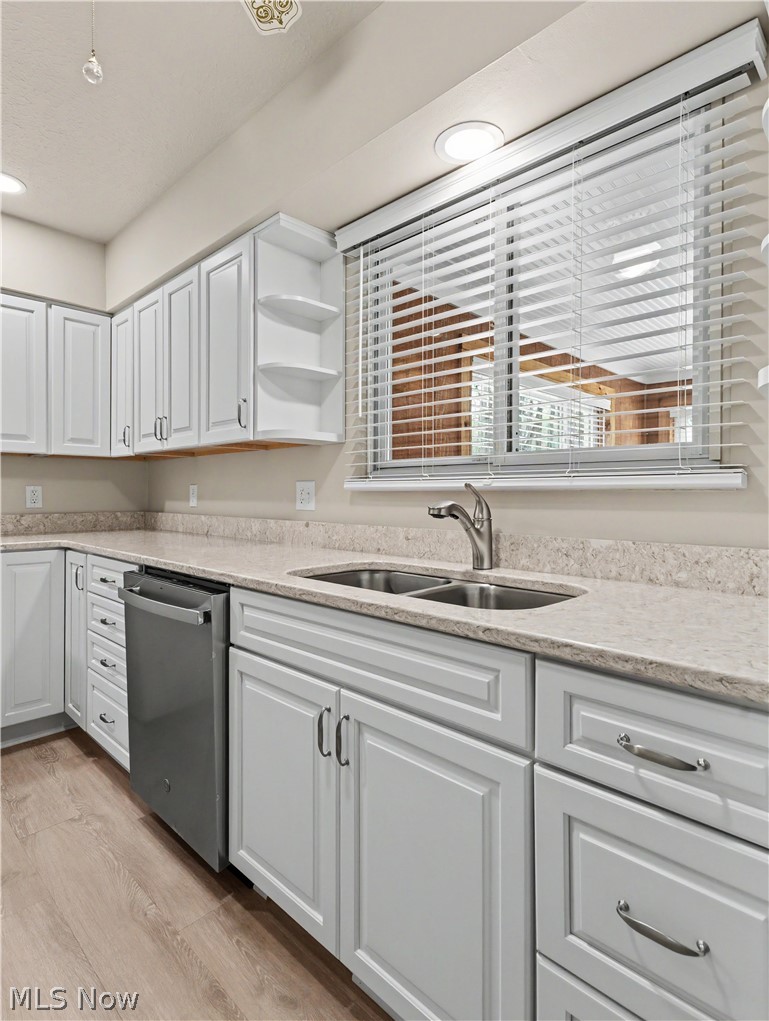 8406 Whipporwill Road Ravenna, OH 44266 - Photo 11 of 26 Kitchen with quartz countertops, dishwasher and under mount sink looking to enclosed porch