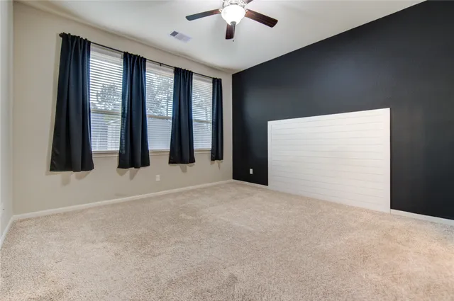 a view of an empty room with windows