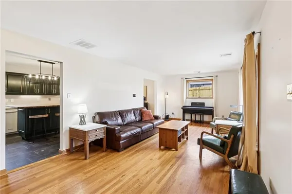 a living room with furniture flat screen tv and a fireplace
