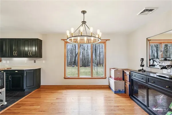 a kitchen with stainless steel appliances a stove a sink and a wooden floors