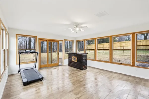 a living room with furniture and a large window with balcony view