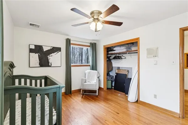 a bedroom with furniture and a wooden floor