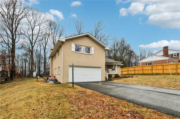 a view of a house with snow on the road