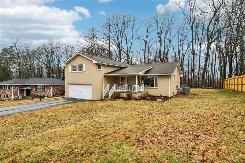 862 White Farm Road Indiana, PA 15701 - Photo 4 of 49 a front view of a house with a yard and garage