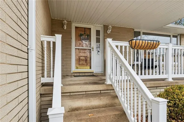 a view of staircase with railing and white walls