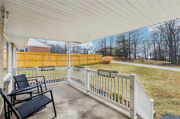 a view of a porch with furniture and floor to ceiling window