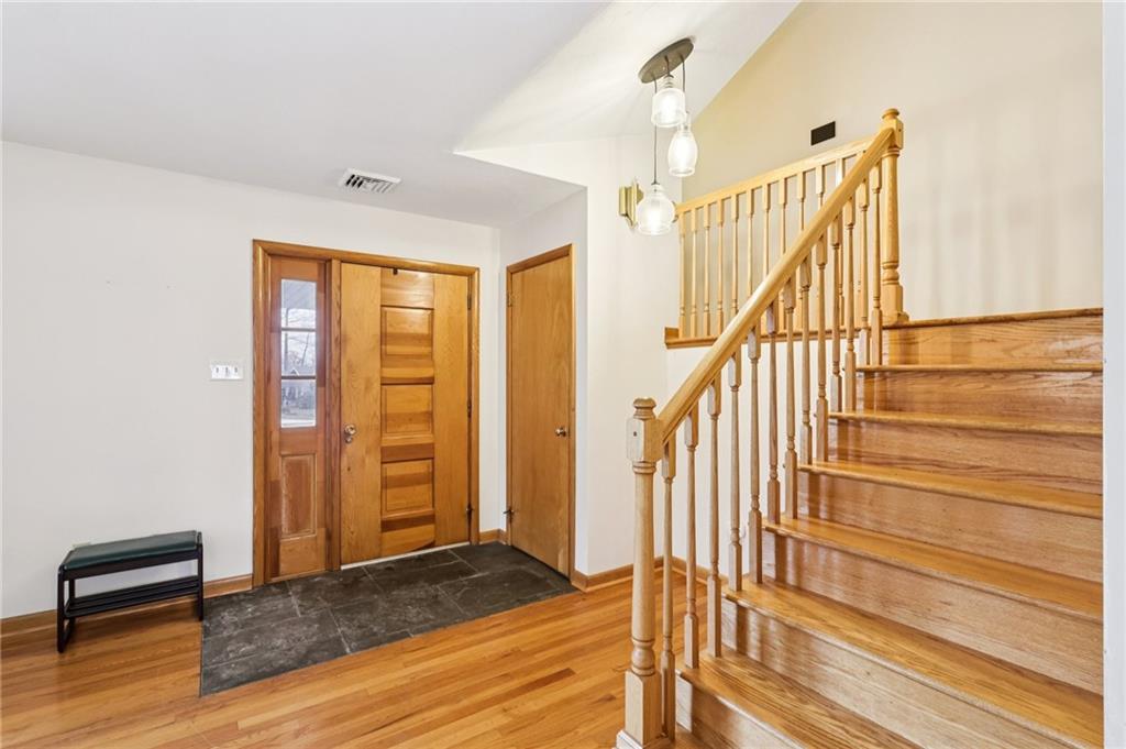 862 White Farm Road Indiana, PA 15701 - Photo 8 of 49 a view of a hallway with wooden floor and staircase