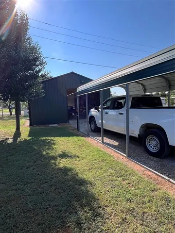 a view of an house with backyard space and sitting area