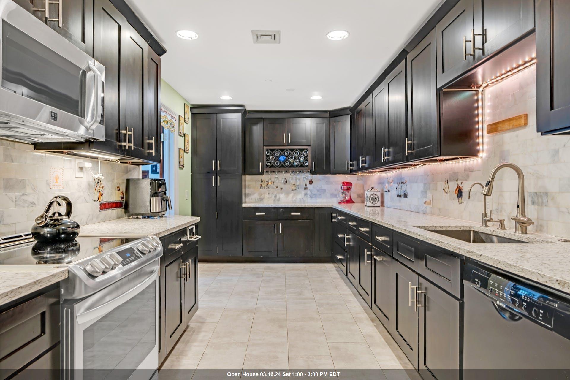 a kitchen with stainless steel appliances a sink stove top oven and refrigerator