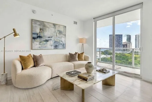 a living room with furniture and a large window