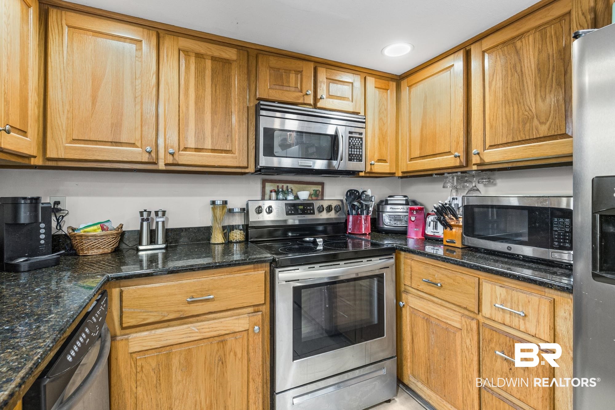 114 Du Rhu Drive, Unit A Mobile, AL 36608 - Photo 6 of 14 Kitchen featuring stainless steel appliances, wood finish cabinets, dark stone countertops, and recessed lighting