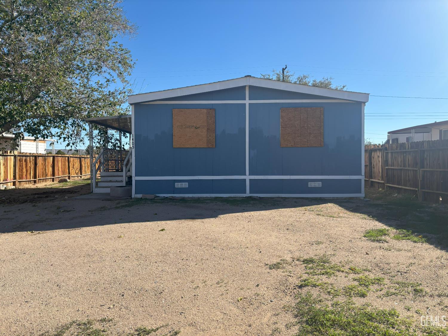 Undisclosed Address Ridgecrest, CA 93555 - Photo 8 of 27 a front view of a house with a yard