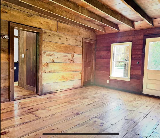 a view of a room with wooden floor and window