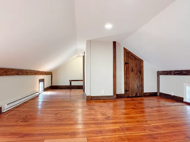 a view of a room with wooden floor