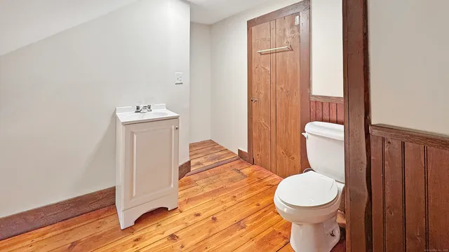 a white toilet sitting next to a bathroom sink