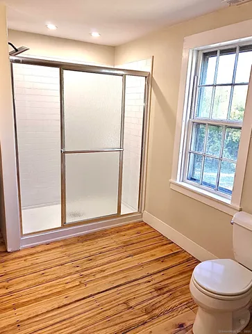 a bathroom with a window and a shower