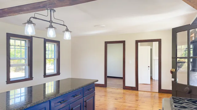 a view of a room with wooden floor and windows