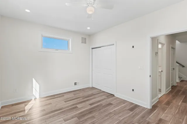 a view of a room with wooden floor and white walls