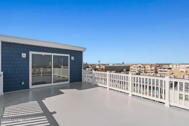 a view of a balcony with a floor to ceiling window and wooden floor
