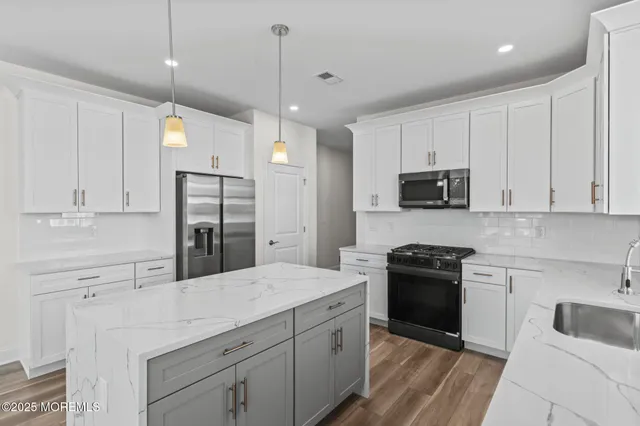 a kitchen with a sink stove and refrigerator