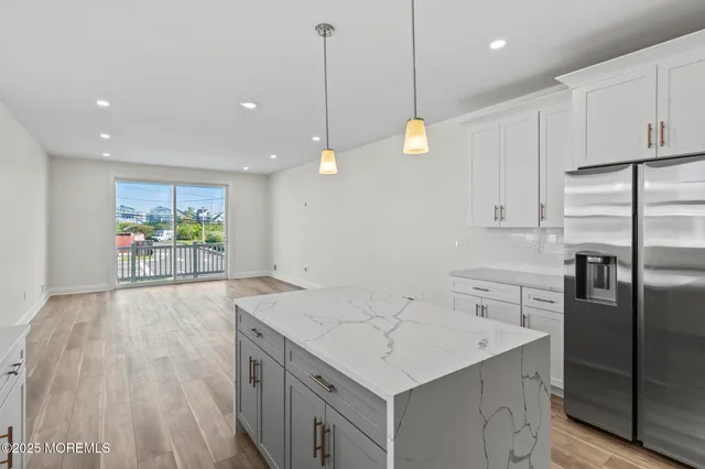 a kitchen with a sink center island and stainless steel appliances