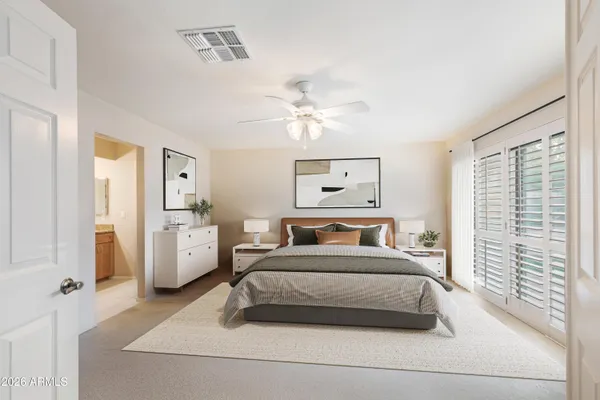 a bedroom with a bed and a chandelier