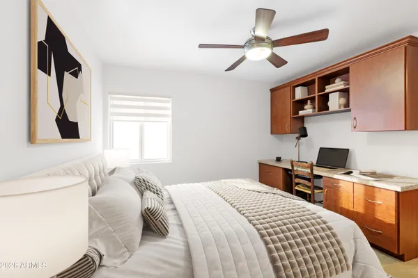 a bedroom with a large bed and a chandelier