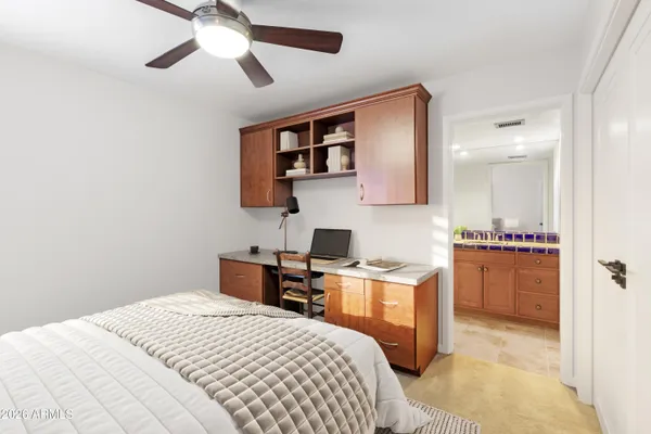 a bedroom with a bed and a desk