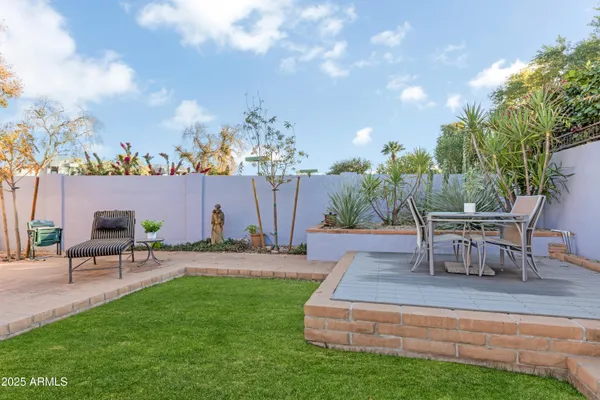 a view of a house with backyard and sitting area