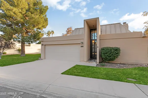 a front view of a house with a yard and garage