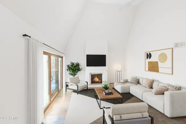 a living room with furniture a flat screen tv and a large window