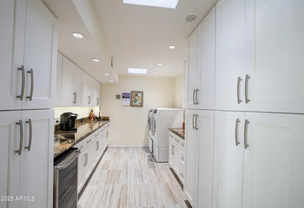 a kitchen with granite countertop a refrigerator stove top oven and sink