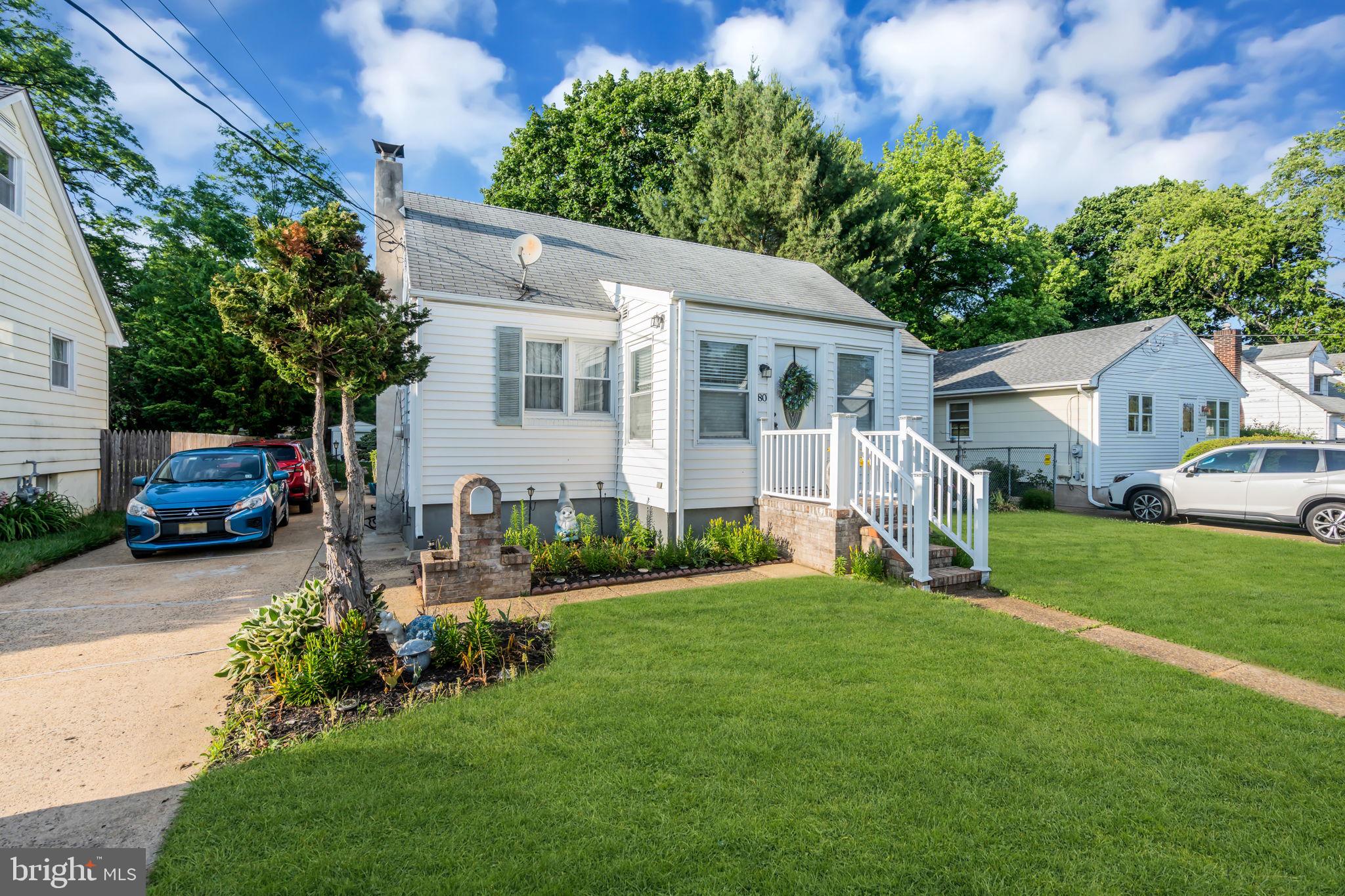 80 Locust Avenue Hamilton, NJ 08620 - Photo 3 of 24 a front view of a house with a garden and trees