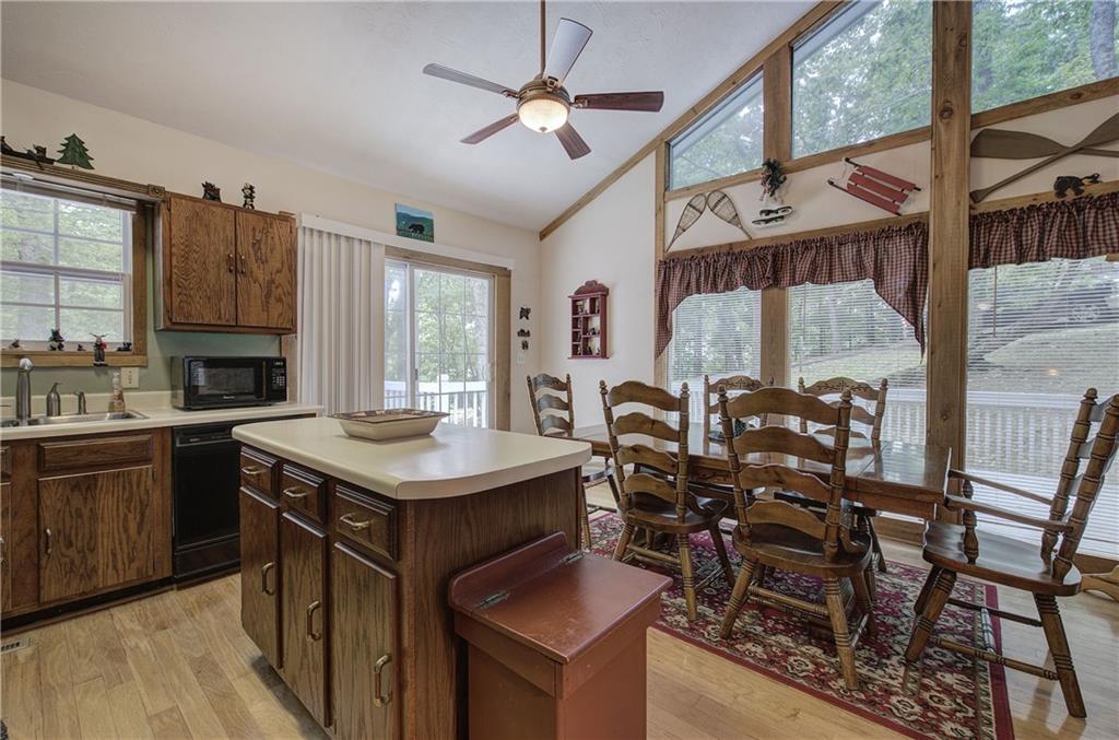 214 South View Trail Jasper, GA 30143 - Photo 13 of 72 a kitchen with a stove a sink dishwasher a dining table and chairs with wooden floor